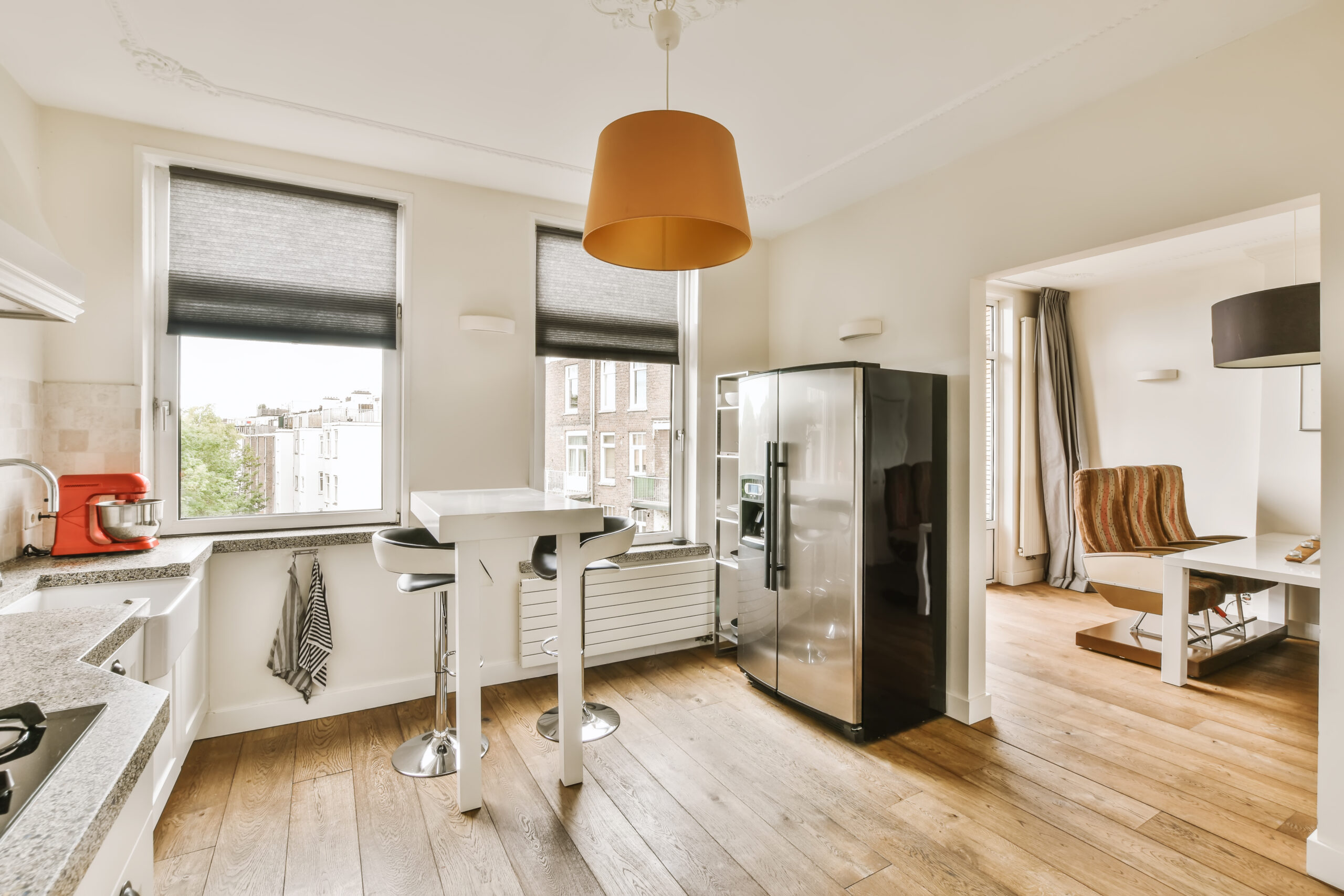 a kitchen with a stainless steel refrigerator and a window